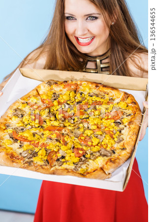 Woman holding big pizza in box Woman holding big pizza in box 136544655