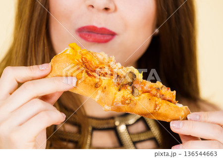 Woman eating hot pizza slice Woman eating hot pizza slice 136544663