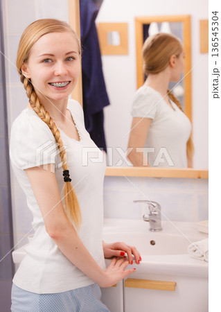 Happy woman reflecting in mirror Happy woman reflecting in mirror 136545304