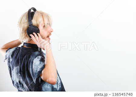 cool guy having fun listens to music in headphones 136545740