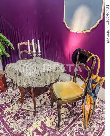 An eclectic and theatrical still life. This vintage-inspired room features antique furniture, a candelabra, and unique props creating a mysterious mood. High quality photo An eclectic and theatrical still life. This vintage-inspired room features antique furniture, a candelabra, and unique props creating a mysterious mood. High quality photo 136546431