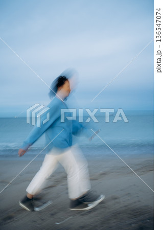 Motion Blur of Person Walking on Beach Motion Blur of Person Walking on Beach 136547074