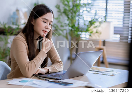 Business woman at desk in office for celebration of goals or target. Business woman at desk in office for celebration of goals or target. 136547290