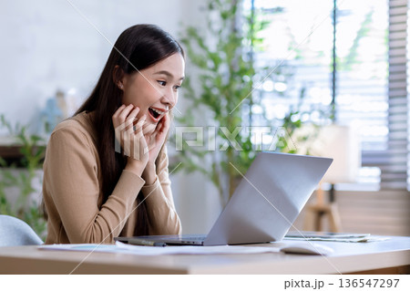 Business woman at desk in office for celebration of goals or target. 136547297