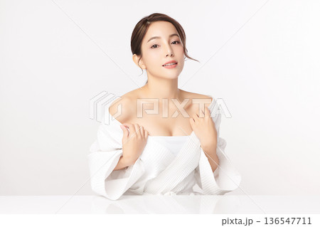 A beautiful young Asian woman with clean, fresh skin against a white background. Skincare, facial treatment, cosmetology, beauty, and spa. An elegant portrait of an Asian woman. A beautiful young Asian woman with clean, fresh skin against a white background. Skincare, facial treatment, cosmetology, beauty, and spa. An elegant portrait of an Asian woman. 136547711