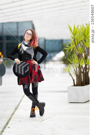 Young woman showing alternative urban fashion style outdoors Young woman showing alternative urban fashion style outdoors 136548607