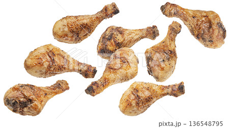 Falling grilled chicken legs, roasted drumsticks isolated on white background, full depth of field Falling grilled chicken legs, roasted drumsticks isolated on white background, full depth of field 136548795