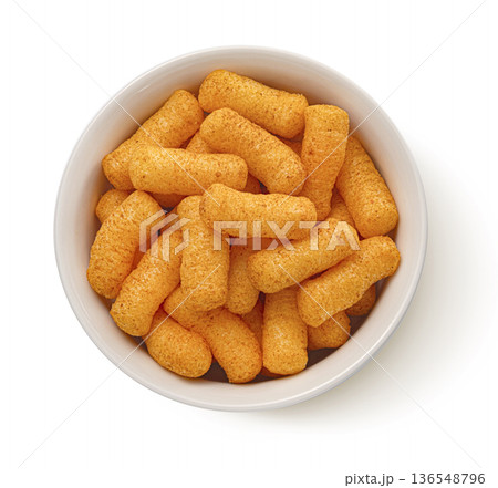 Crispy corn sticks snack in bowl isolated on white background, top view, full depth of field Crispy corn sticks snack in bowl isolated on white background, top view, full depth of field 136548796