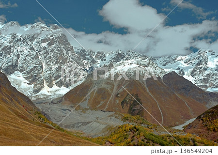 A trekking trail to the Shkhara Glacier from Ushguli. An autumn valley in the Caucasus Mountains. A trekking trail to the Shkhara Glacier from Ushguli. An autumn valley in the Caucasus Mountains. 136549204
