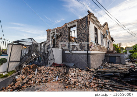 Bila Tserkva, Kyiv region, Ukraine 09.06.2025: Heavily damaged brick building with collapsed sections, charred walls, broken windows, and scattered debris after a destructive event. Bila Tserkva, Kyiv region, Ukraine 09.06.2025: Heavily damaged brick building with collapsed sections, charred walls, broken windows, and scattered debris after a destructive event. 136550007