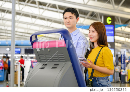 空港でキオスク操作する二人 ■撮影協力：関西国際空港（KIX） 136550253