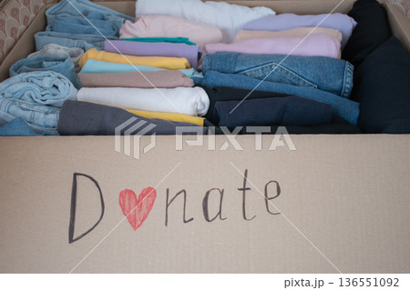 Box filled with neatly folded clothes ready for donation at a local charity for those in need Box filled with neatly folded clothes ready for donation at a local charity for those in need 136551092