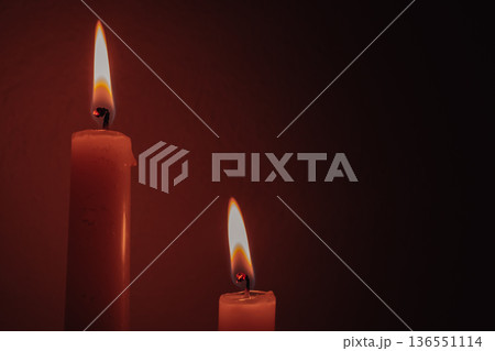 Two burning candles during energy blackout, glowing flames in dark room provide warmth and light, domestic survival concept for electricity power outage Two burning candles during energy blackout, glowing flames in dark room provide warmth and light, domestic survival concept for electricity power outage 136551114