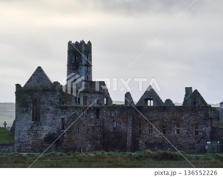 Historic Abbey ruins in Ireland stand under a cloudy morning sky. 136552226