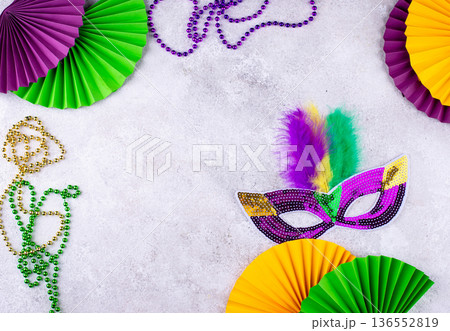 Vibrant Mardi Gras background with mask, beads, and festive decorations Vibrant Mardi Gras background with mask, beads, and festive decorations 136552819