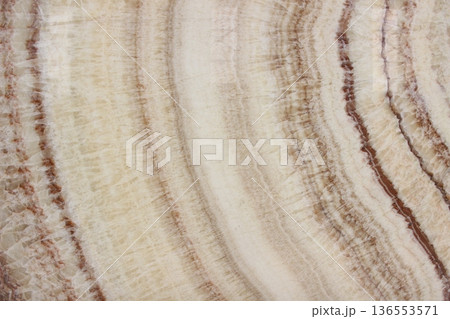 Cream rainbow onyx marble texture with concentric circular patterns and beautiful natural brownish orange veins. 136553571