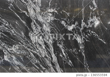 Detailed texture of Copacabana marble with black to grey color gradations and highly expressive white vein patterns for interior decoration. Detailed texture of Copacabana marble with black to grey color gradations and highly expressive white vein patterns for interior decoration. 136553594
