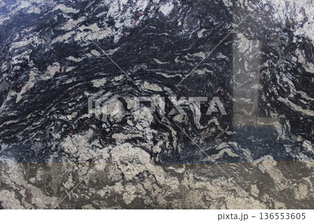 Black and grey marble texture with interlocking dynamic veins, natural stone material for artistic countertops and flooring surfaces. Black and grey marble texture with interlocking dynamic veins, natural stone material for artistic countertops and flooring surfaces. 136553605
