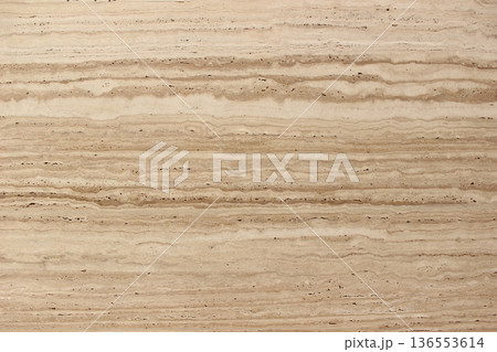 Detail of light brown Travertine stone texture with unique layered veins for architectural applications and home decor. 136553614