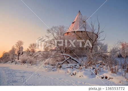 A winter scene with a snow-covered landscape and an ancient fortress. 136553772