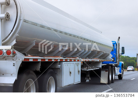 Truck transports fuel on highway in typical road setting Truck transports fuel on highway in typical road setting 136553784