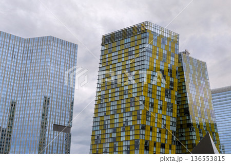 Modern buildings with glass facades yellow accents in an urban setting 136553815