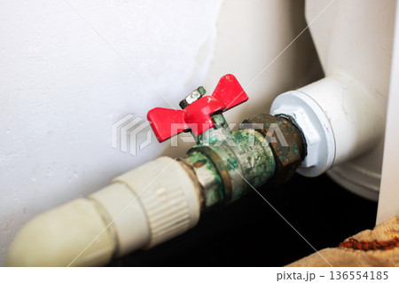 Scene depicts severely corroded pipe joint with signs of moisture and ongoing seepage activity 136554185