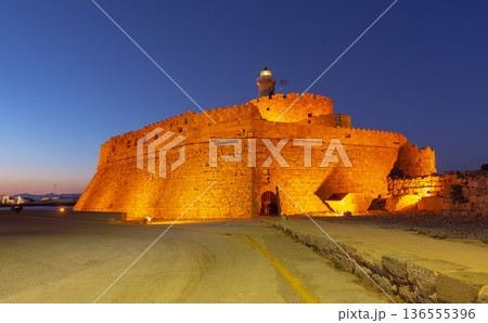 St Nicholas Fortress Illuminated at Night in Rhodes Harbor, Greece St Nicholas Fortress Illuminated at Night in Rhodes Harbor, Greece 136555396