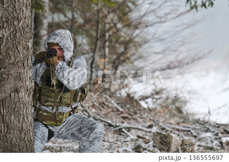 Winter Camouflage Soldier Aiming Rifle in Snowy Forest During Tactical Military Training And Reconnaissance Winter Camouflage Soldier Aiming Rifle in Snowy Forest During Tactical Military Training And Reconnaissance 136555697