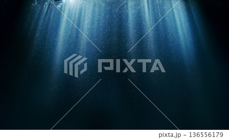 Dark Blue Ocean Surface Seen from Underwater. Abstract Waves and Rays of Sunlight Shining Through 136556179
