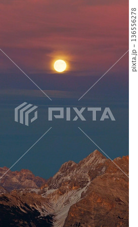 Panorama of the Dolomites mountains with full moon during sunset. Beautiful mountians of Alpi Dolomiti in Italy, South Tirol Panorama of the Dolomites mountains with full moon during sunset. Beautiful mountians of Alpi Dolomiti in Italy, South Tirol 136556278