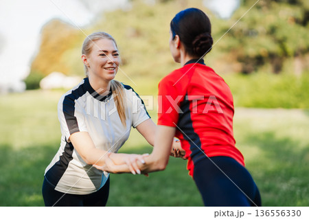 Women enjoy outdoor workout together Women enjoy outdoor workout together 136556330