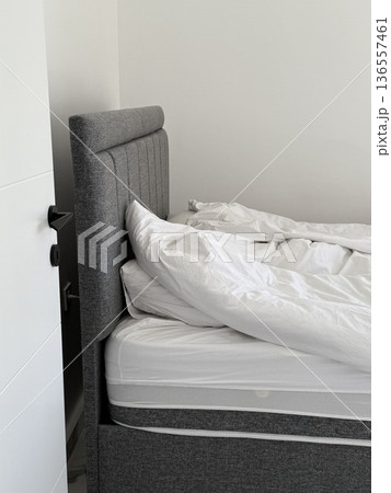 Minimalist modern sofa with white cushions in a clean indoor setting suitable for backgrounds Minimalist modern sofa with white cushions in a clean indoor setting suitable for backgrounds 136557461