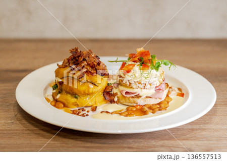 Gourmet breakfast plates with eggs benedict and savory pumpkin stack 136557513
