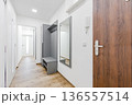 Modern apartment hallway interior with furniture and white walls 136557514