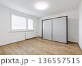 Empty modern apartment bedroom with sliding wardrobe and window 136557515
