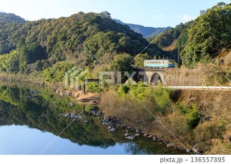 四万十川の清流に沿って予土線の気動車が西ヶ方のめがね橋を渡る 136557895