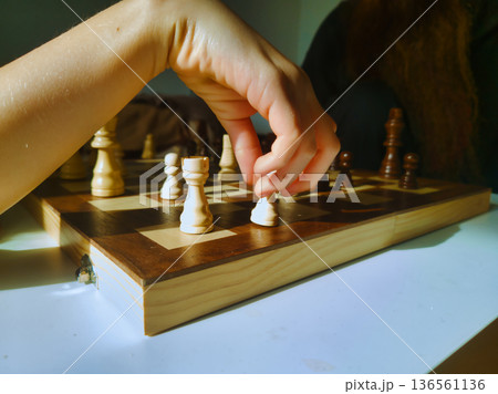 Budapest Family Home Chess Game Final Move with Child Hand in Focus on Wooden Board under Warm Morning Light Interior Lifestyle Photography Hungary Residential Zuglo District Budapest Family Home Chess Game Final Move with Child Hand in Focus on Wooden Board under Warm Morning Light Interior Lifestyle Photography Hungary Residential Zuglo District 136561136
