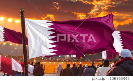 Qatar Flag Waving at Sunset by the Sea 136563442