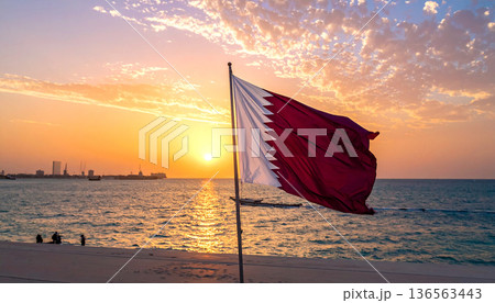 Qatar Flag Waving at Sunset by the Sea Qatar Flag Waving at Sunset by the Sea 136563443
