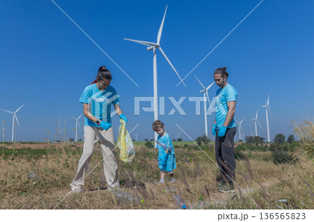 Family collecting garbage at park 136565823