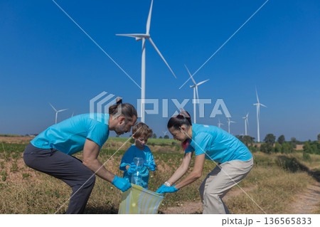 Family collecting garbage at park 136565833