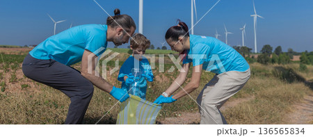 Family collecting garbage at park 136565834