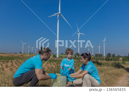 Family collecting garbage at park 136565835