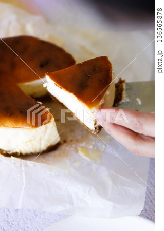 Cheesecake with baking paper on white marble table. 136565878