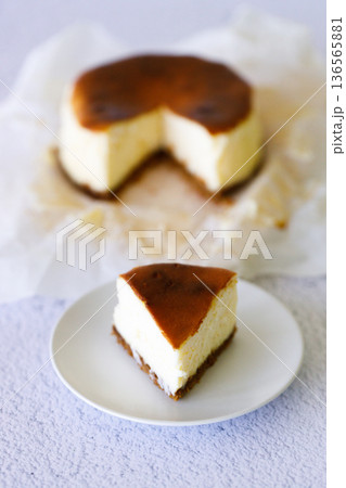 Cheesecake with baking paper on white marble table. 136565881