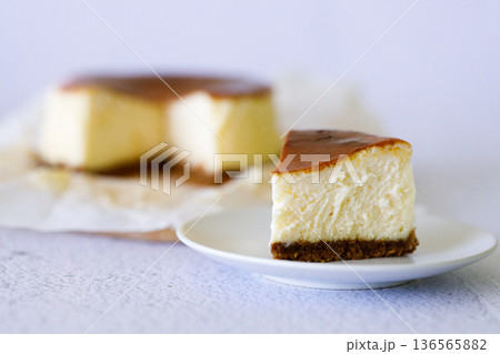 Cheesecake with baking paper on white marble table. 136565882