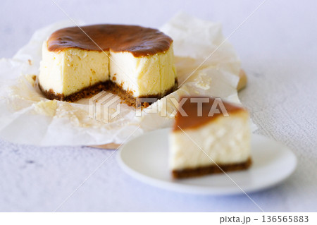 Cheesecake with baking paper on white marble table. 136565883