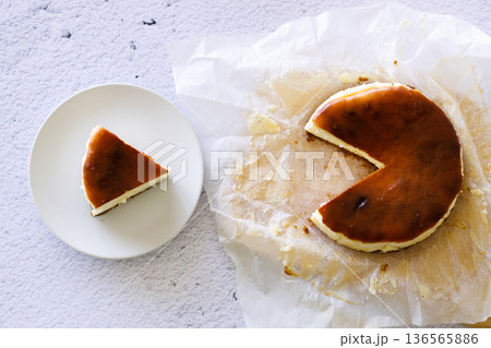 Cheesecake with baking paper on white marble table. Cheesecake with baking paper on white marble table. 136565886