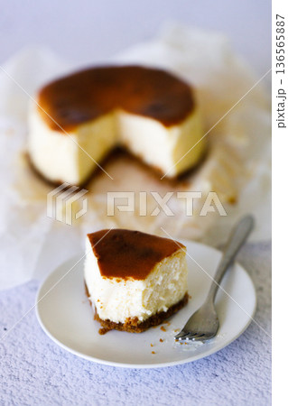 Cheesecake with baking paper on white marble table. Cheesecake with baking paper on white marble table. 136565887